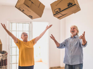Two people throwing "light" moving boxes up in the air.