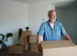 Senior man carrying boxes